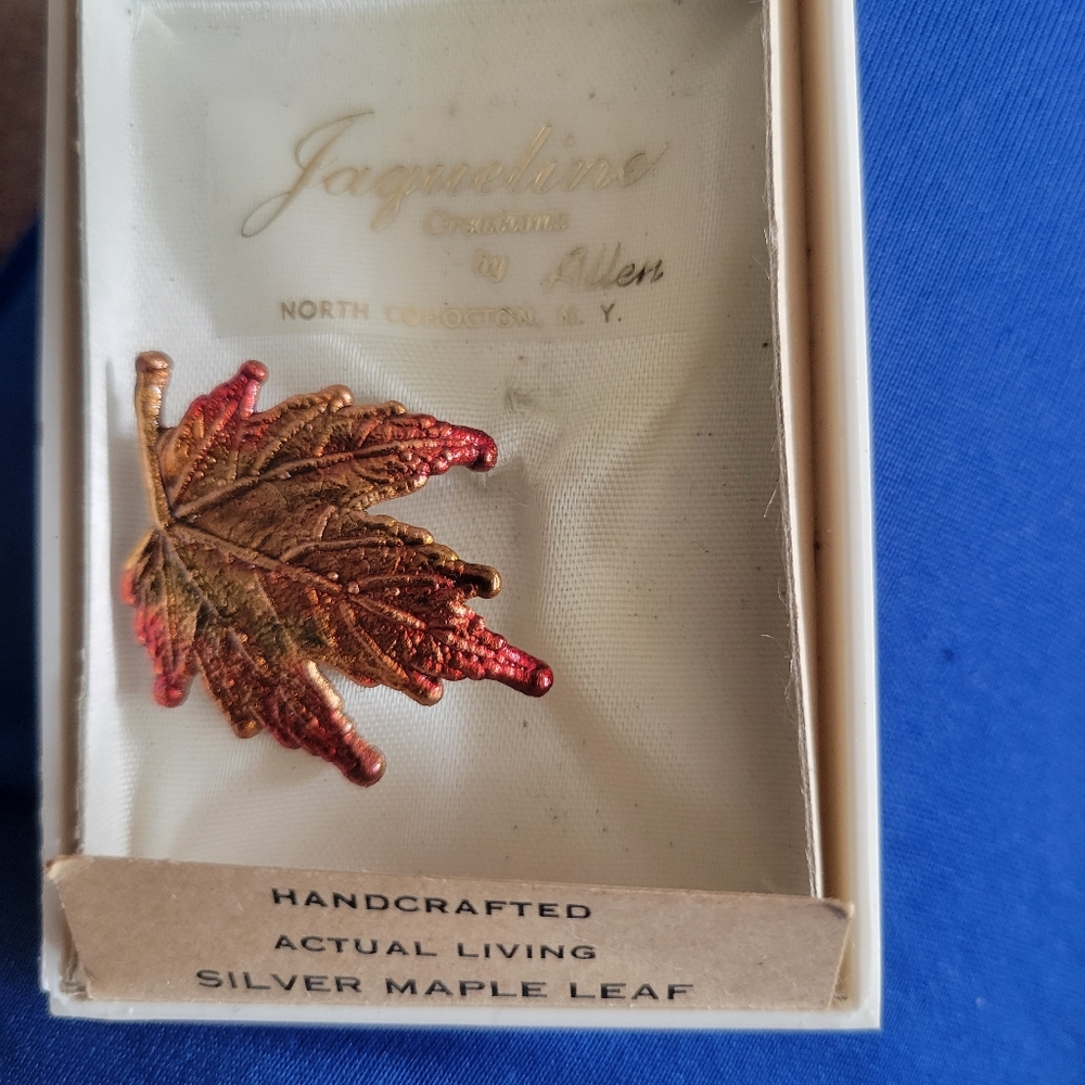 Handcrafted silver maple leaf pin.
